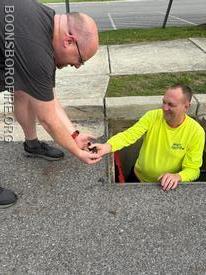 Capt. O’Connor and FF Cochran removing the last of 5 ducks from the drain box